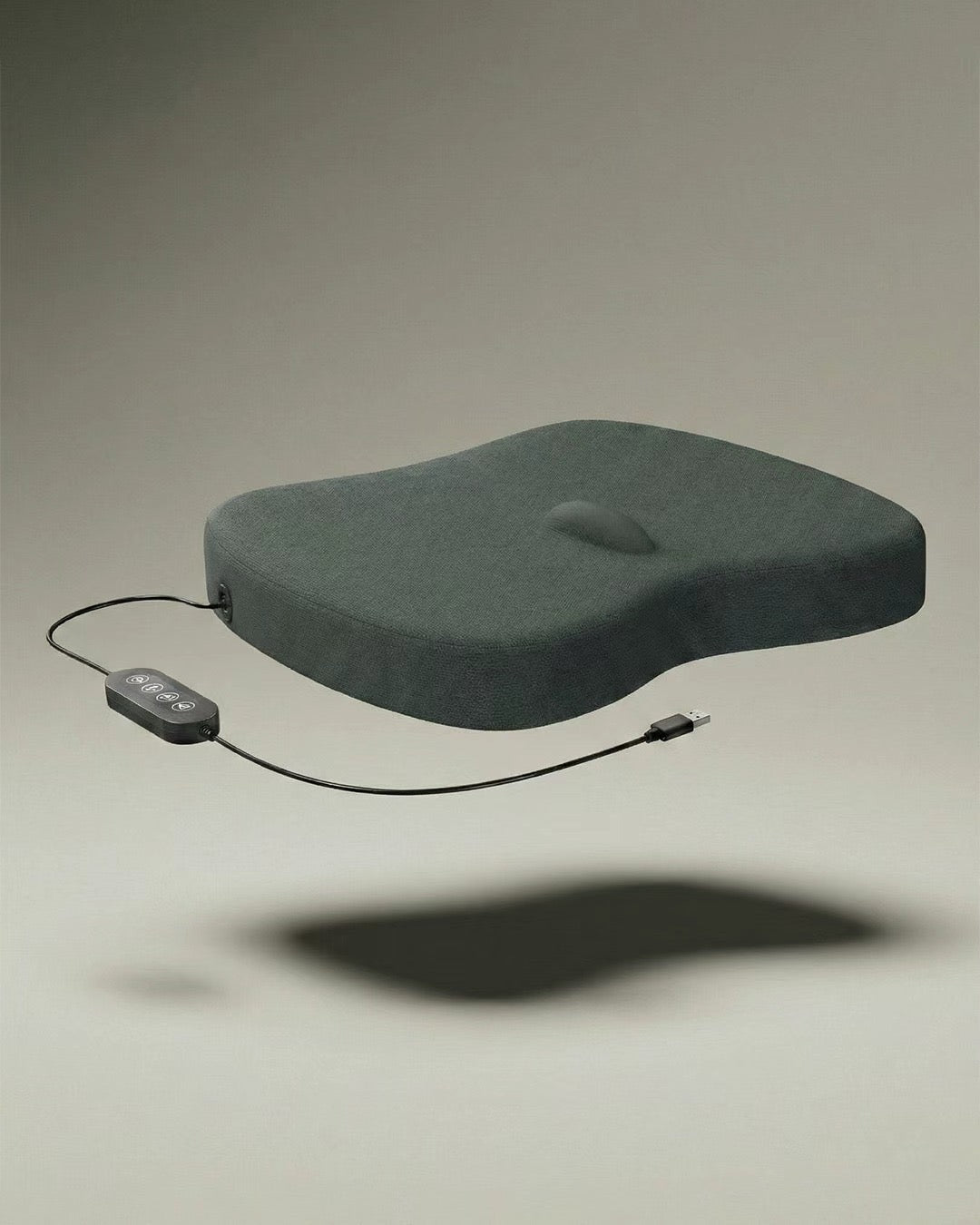 Dark gray Peyako Smart Cushion with wired controller and USB cable on neutral background
